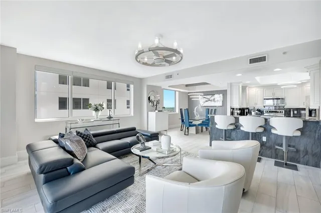 a living room with furniture kitchen and a table