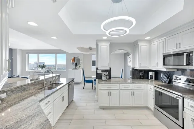 a kitchen with stainless steel appliances a stove sink and cabinets