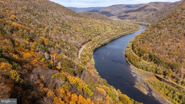 an aerial view of house with yard and mountain view