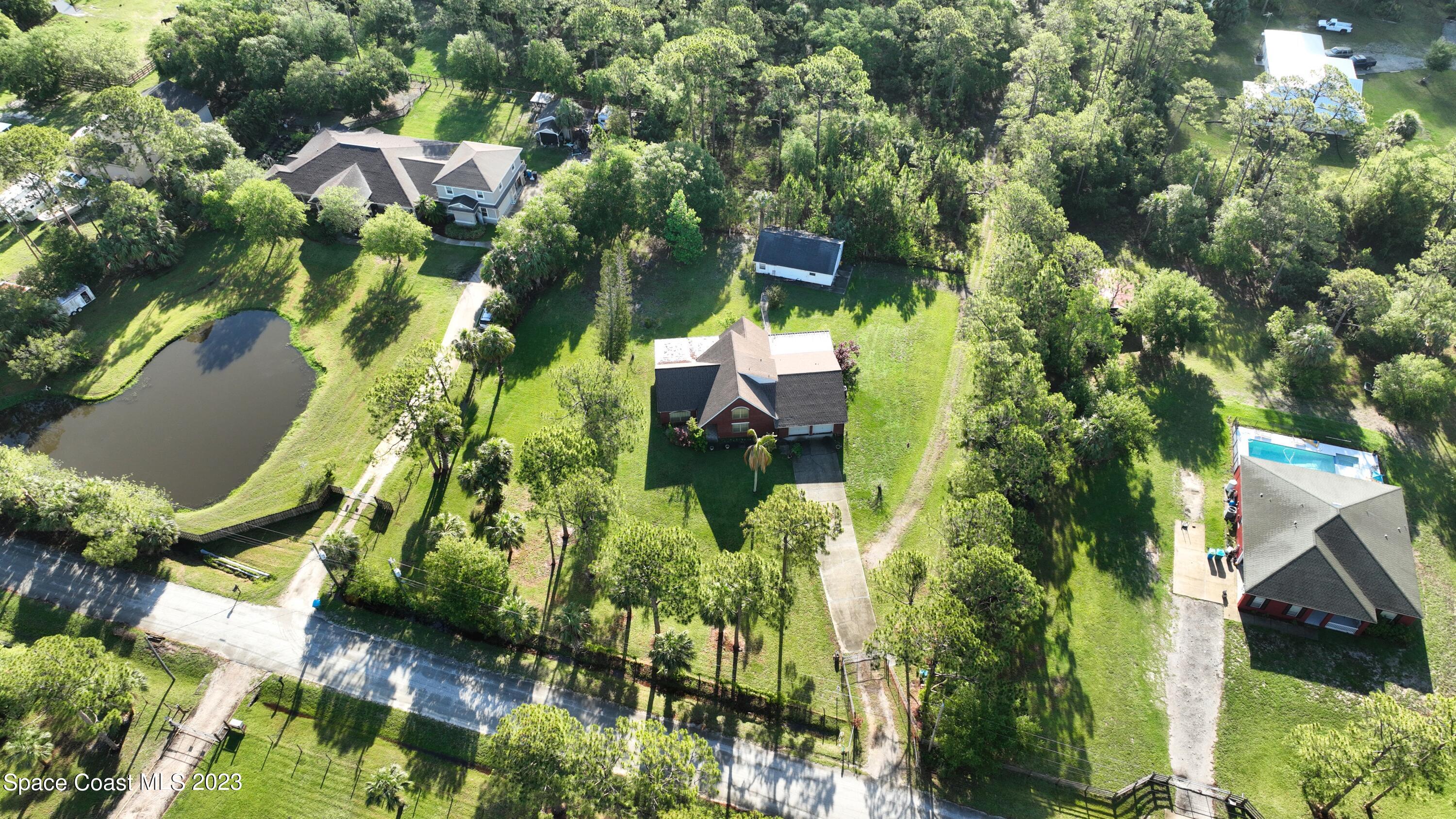 a backyard of a house with a yard and outdoor seating