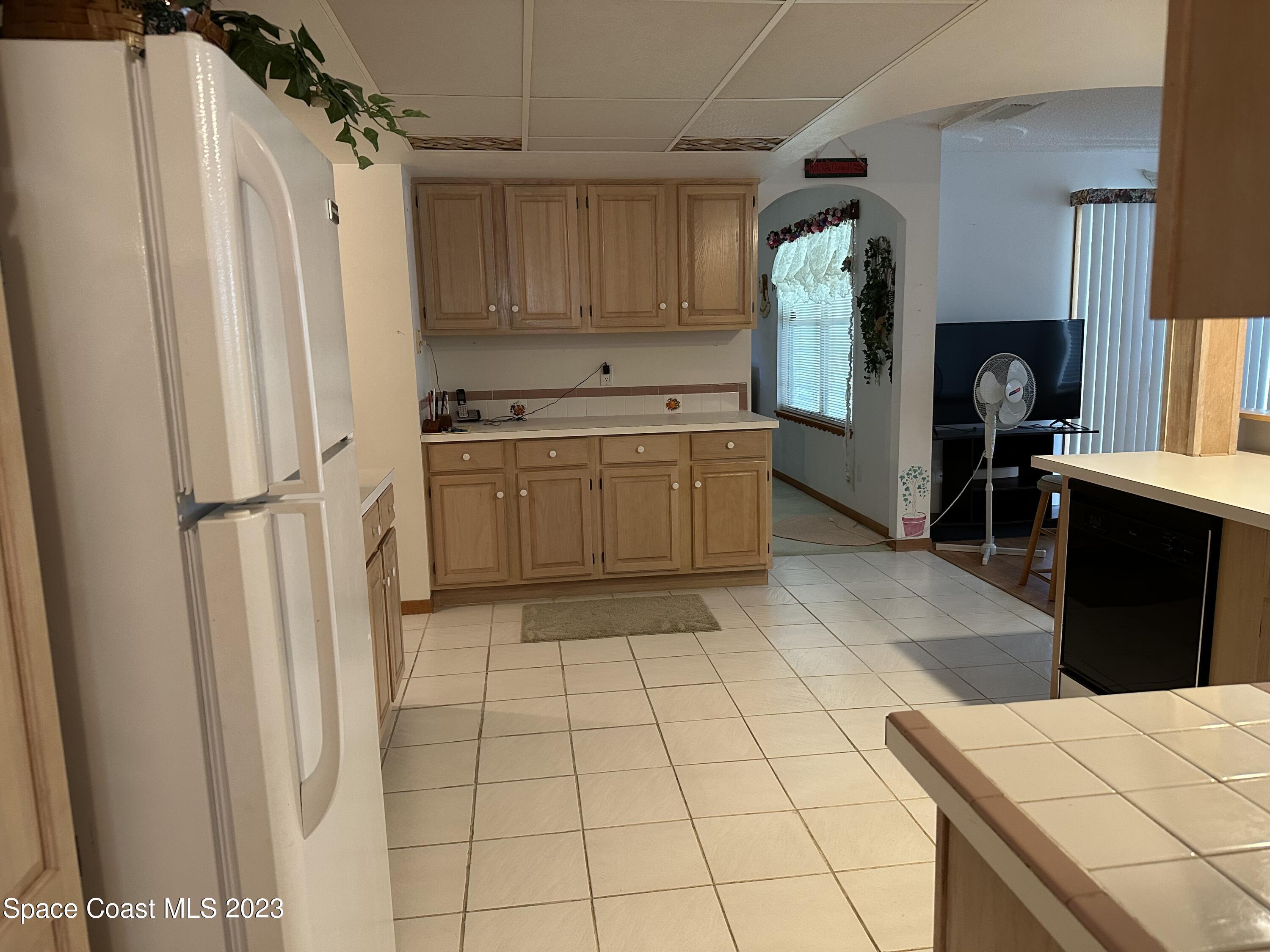 3995 Toby Avenue Malabar, FL 32950 - Photo 11 of 43 a kitchen with stainless steel appliances granite countertop a refrigerator and a sink