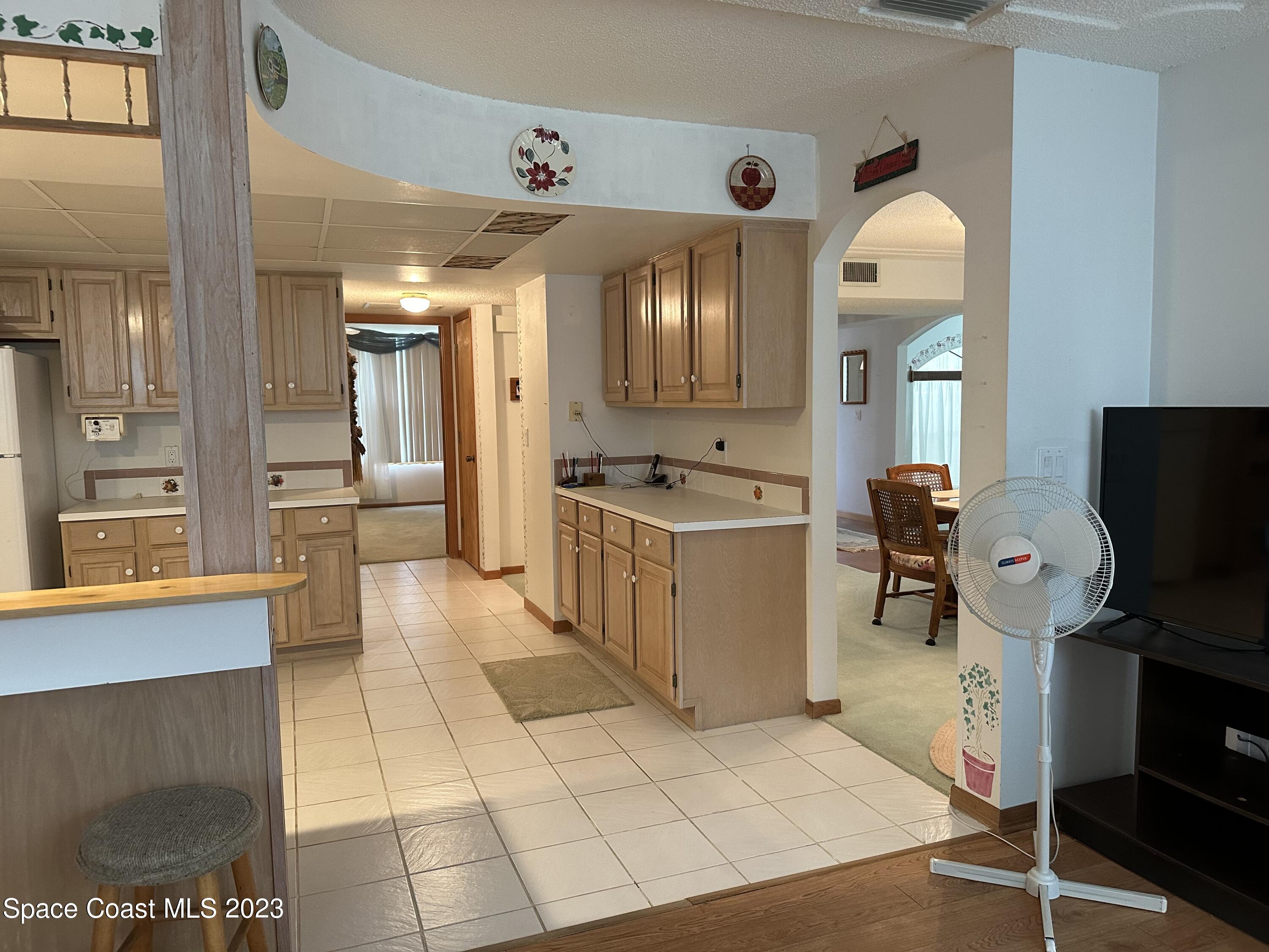 3995 Toby Avenue Malabar, FL 32950 - Photo 17 of 43 a kitchen with stainless steel appliances kitchen island granite countertop a stove a sink and a refrigerator