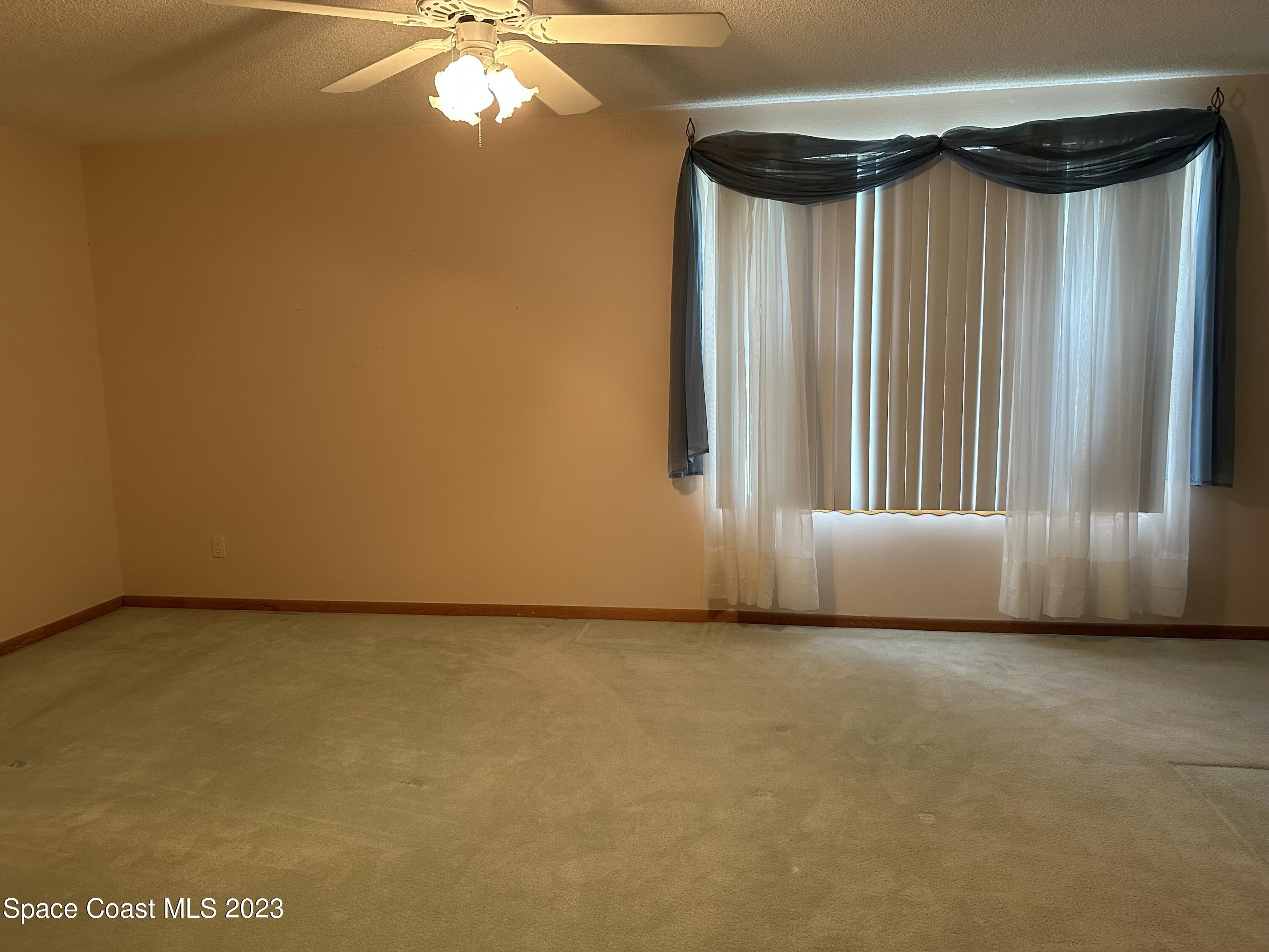 3995 Toby Avenue Malabar, FL 32950 - Photo 20 of 43 a view of a room with a fireplace and a chandelier