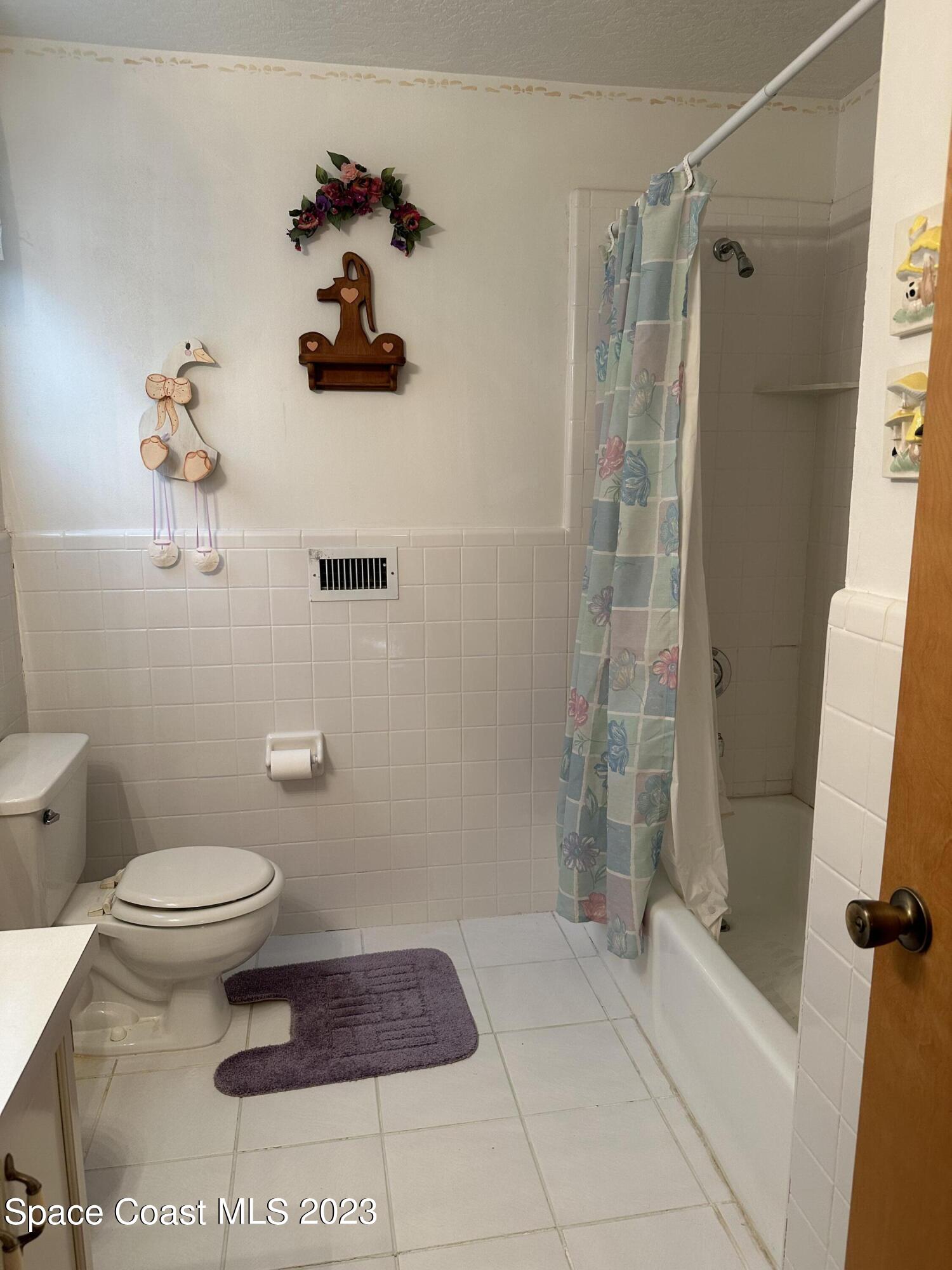 3995 Toby Avenue Malabar, FL 32950 - Photo 29 of 43 a bathroom with a toilet and a shower