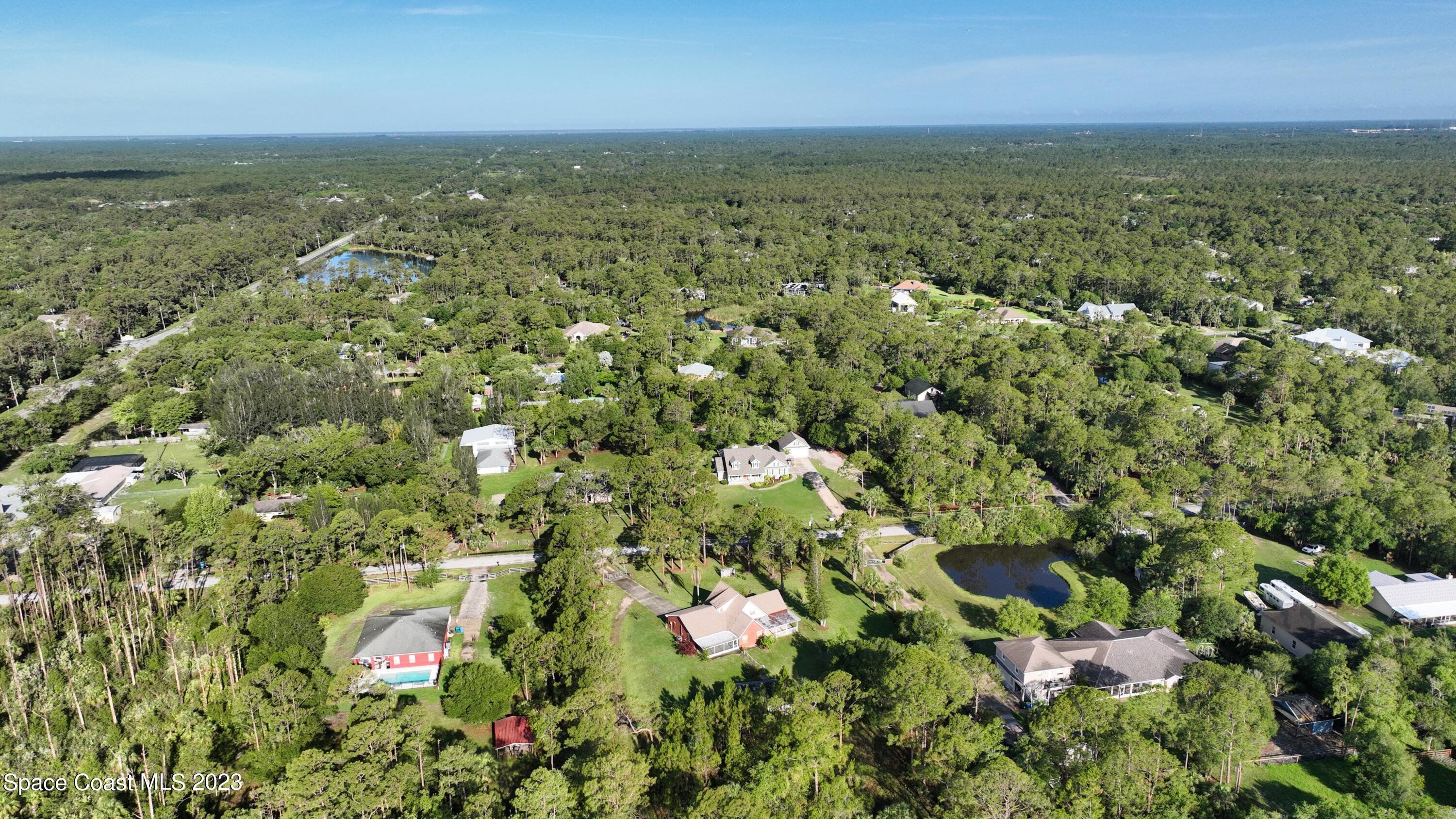 3995 Toby Avenue Malabar, FL 32950 - Photo 3 of 43 an aerial view of residential houses with outdoor space and trees