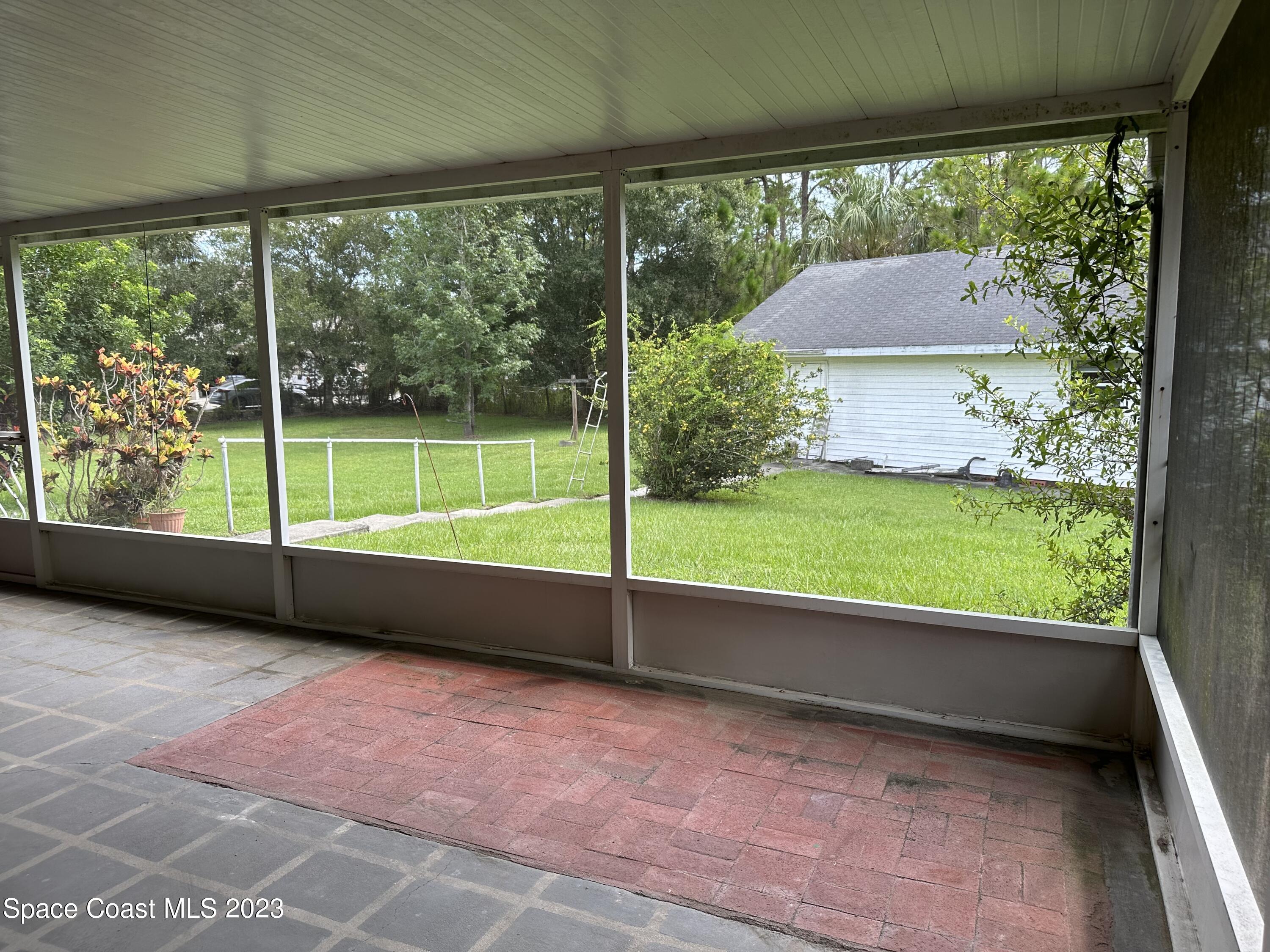 3995 Toby Avenue Malabar, FL 32950 - Photo 38 of 43 a view of a porch with a backyard