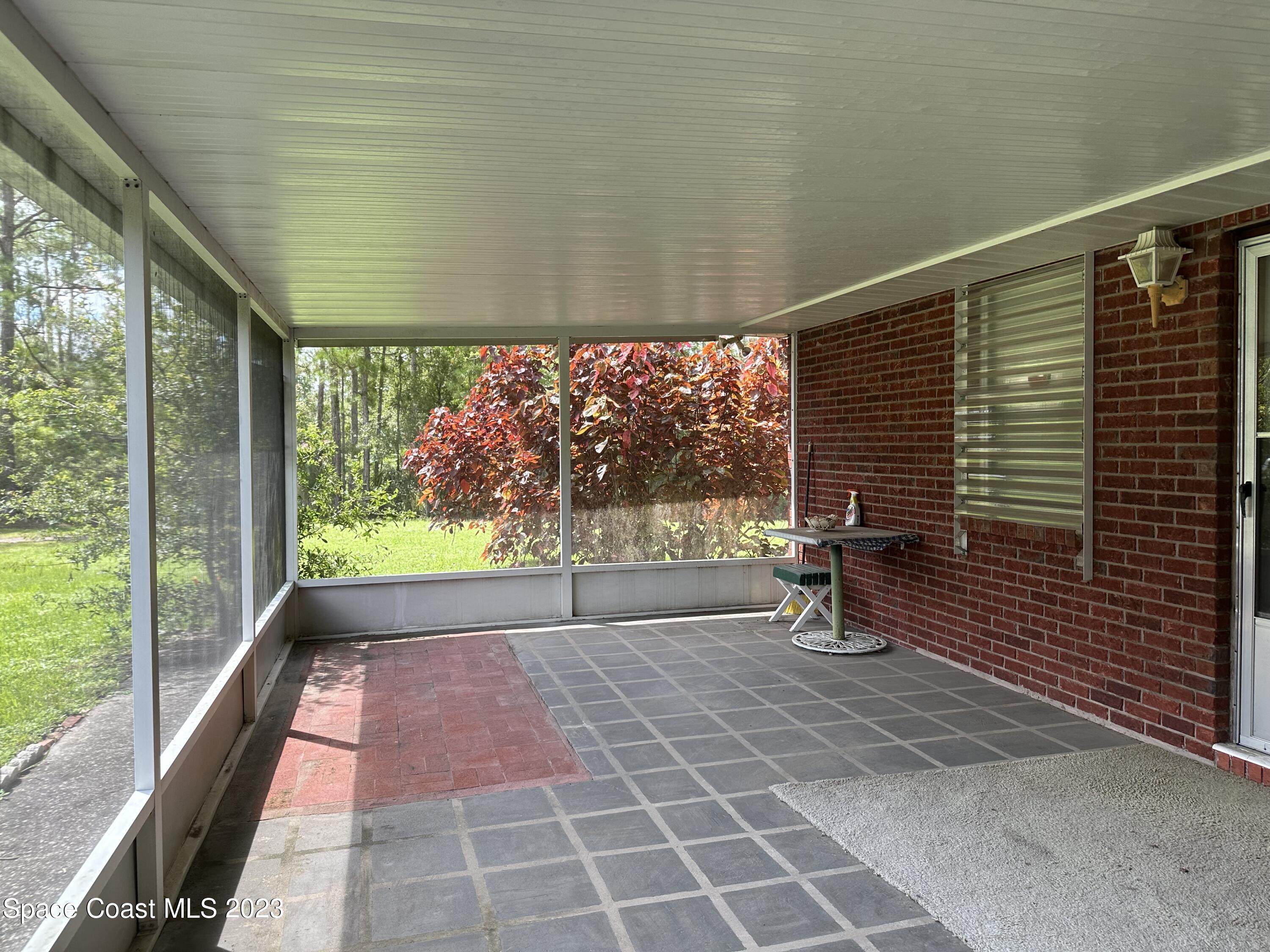 3995 Toby Avenue Malabar, FL 32950 - Photo 39 of 43 a house view with a bench