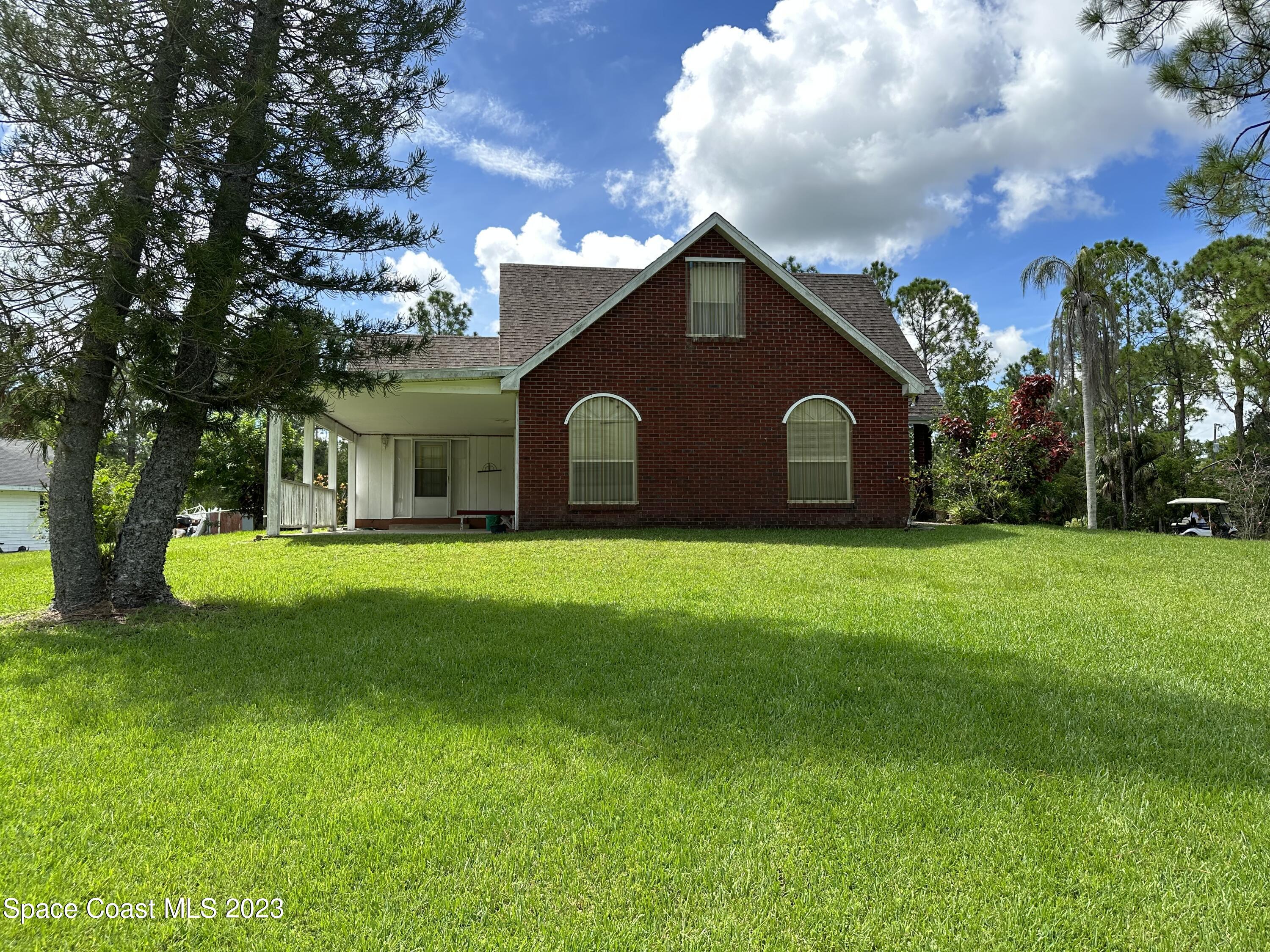 3995 Toby Avenue Malabar, FL 32950 - Photo 42 of 43 a view of a house with a yard