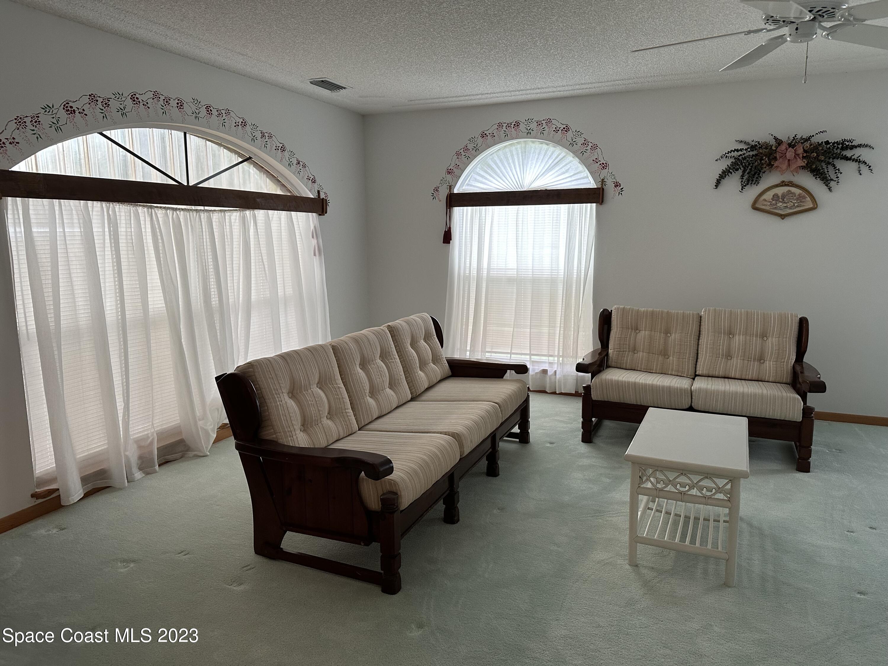 3995 Toby Avenue Malabar, FL 32950 - Photo 8 of 43 a living room with furniture and a large window