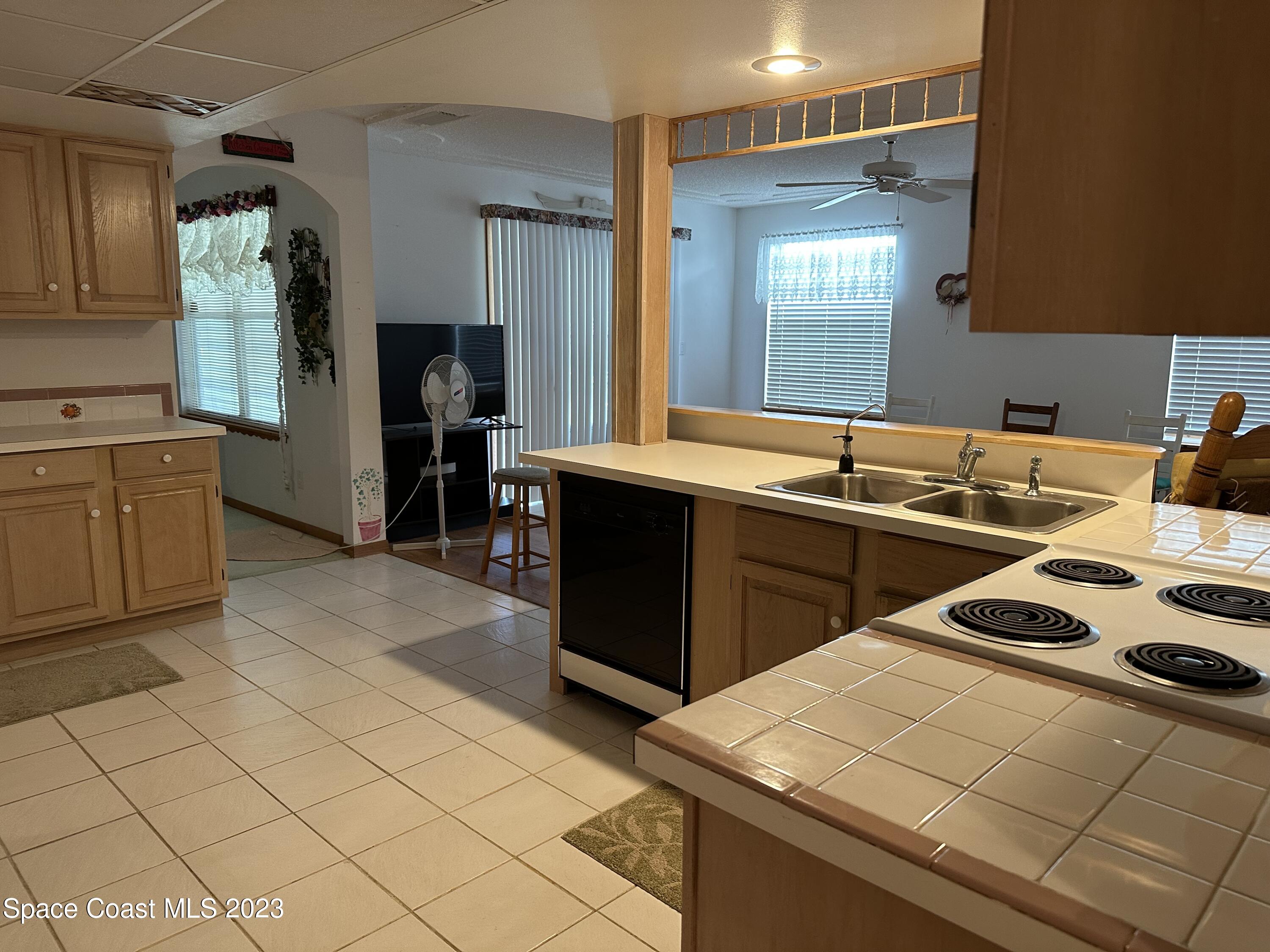 3995 Toby Avenue Malabar, FL 32950 - Photo 10 of 43 a kitchen that has a sink and a stove in it