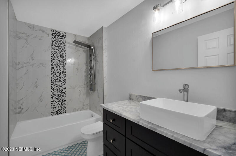 692 Largo Lane Macclenny, FL 32063 - Photo 13 of 41 a bathroom with a sink a toilet and a bathtub