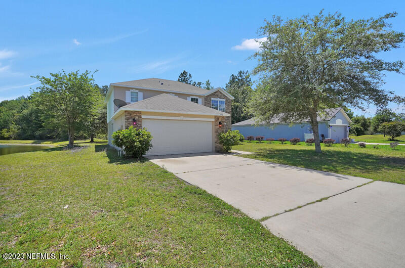 692 Largo Lane Macclenny, FL 32063 - Photo 15 of 41 a front view of a house with garden