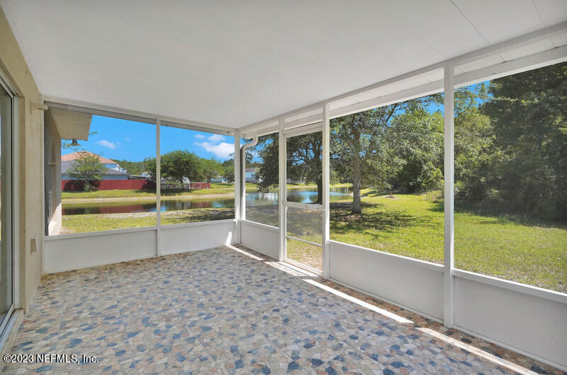 692 Largo Lane Macclenny, FL 32063 - Photo 16 of 41 a view of empty room with floor to ceiling windows