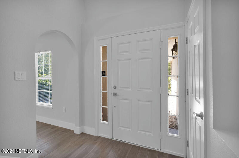 692 Largo Lane Macclenny, FL 32063 - Photo 24 of 41 an empty room with wooden floor cabinet and windows