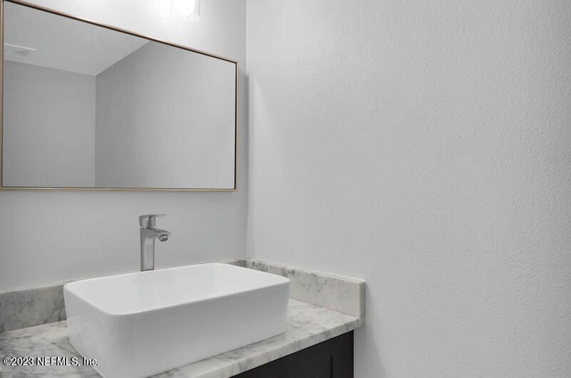 692 Largo Lane Macclenny, FL 32063 - Photo 27 of 41 a bathroom with a sink a mirror and vanity