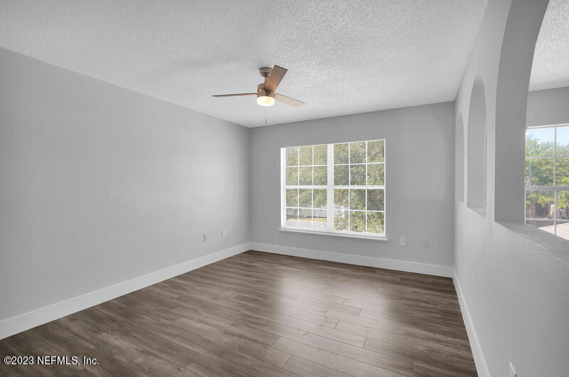 692 Largo Lane Macclenny, FL 32063 - Photo 34 of 41 an empty room with wooden floor and windows