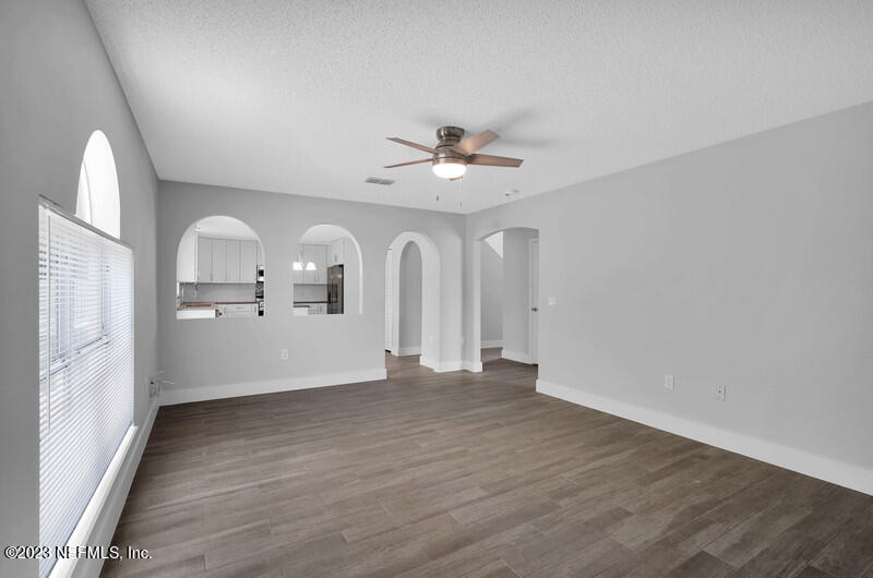 692 Largo Lane Macclenny, FL 32063 - Photo 39 of 41 wooden floor in an empty room with a window