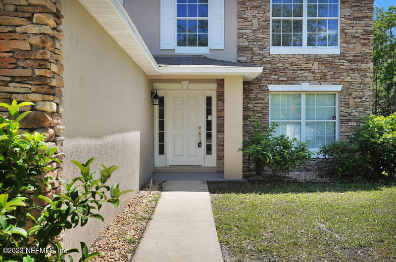 692 Largo Lane Macclenny, FL 32063 - Photo 4 of 41 a front view of a house with a yard