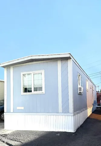 a front view of a house with wooden fence