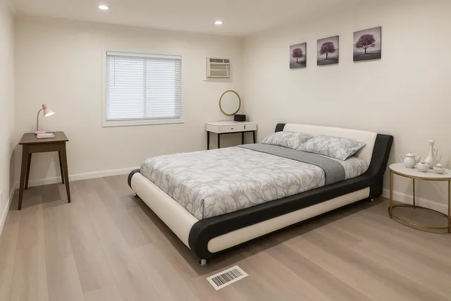 a bedroom with a bed a table and chair