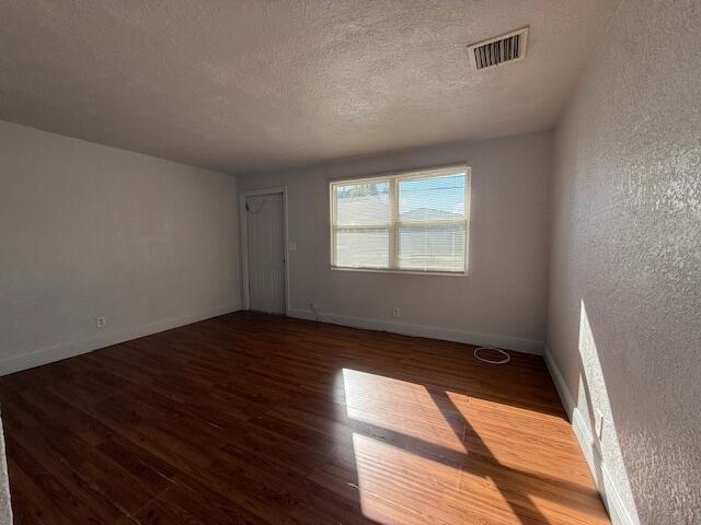 2840 Avenue S A Riviera Beach, Unit 3 Riviera Beach, FL 33404 - Photo 12 of 23 an empty room with wooden floor and windows
