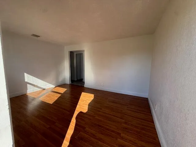 a view of a room with wooden floor