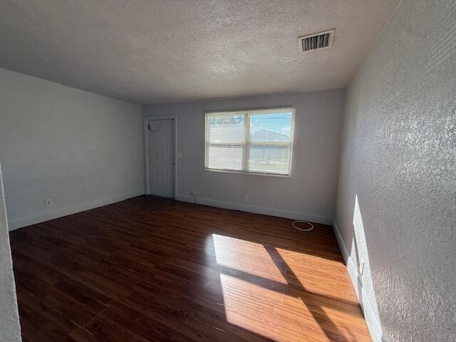 2840 Avenue S A Riviera Beach, Unit 3 Riviera Beach, FL 33404 - Photo 15 of 23 an empty room with wooden floor and windows