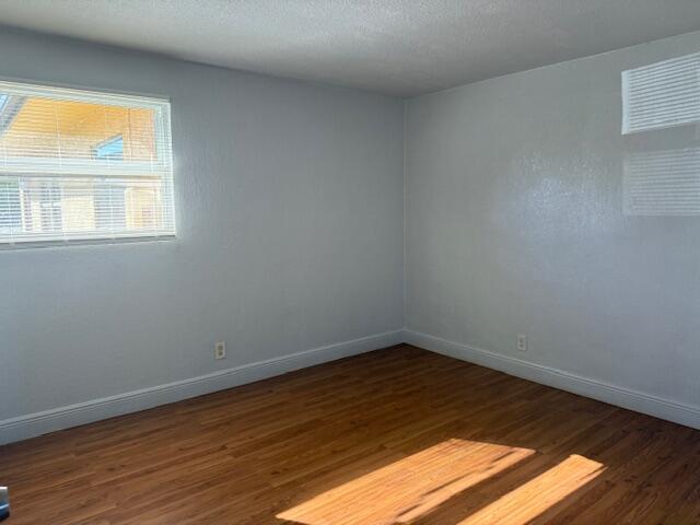 2840 Avenue S A Riviera Beach, Unit 3 Riviera Beach, FL 33404 - Photo 16 of 23 a view of an empty room with wooden floor and a window