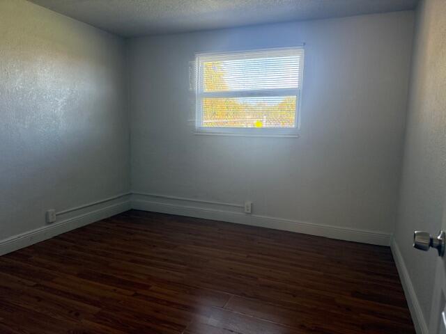 2840 Avenue S A Riviera Beach, Unit 3 Riviera Beach, FL 33404 - Photo 19 of 23 a view of an empty room with wooden floor and a window