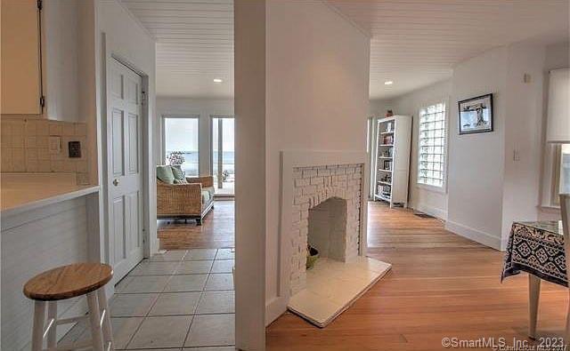 15 Merwin Avenue Milford, CT 06460 - Photo 11 of 23 a living room with furniture a fireplace and a potted plant