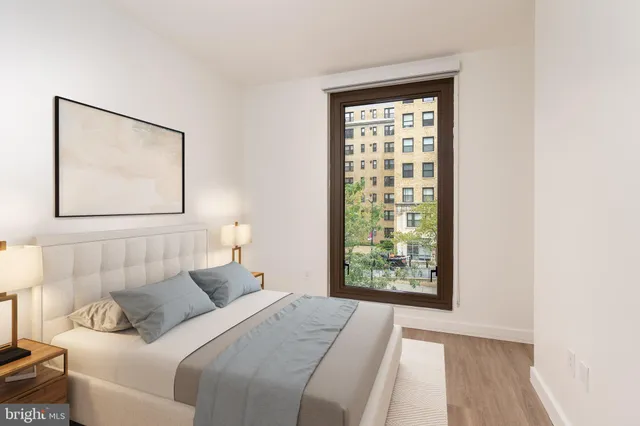 a bedroom with a bed and a window