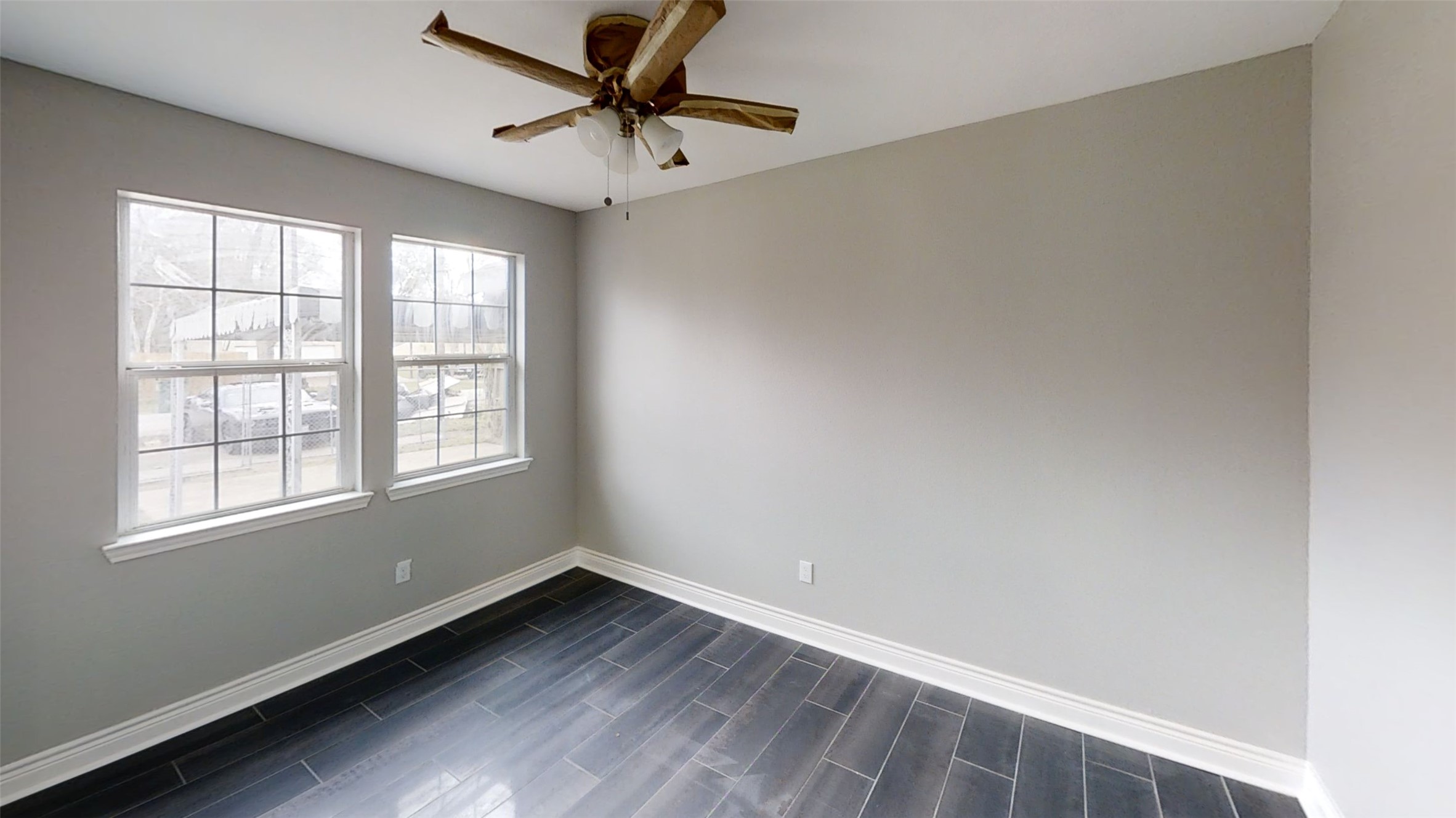 4323 Alice Street Houston, TX 77021 - Photo 11 of 11 an empty room with wooden floor fan and windows