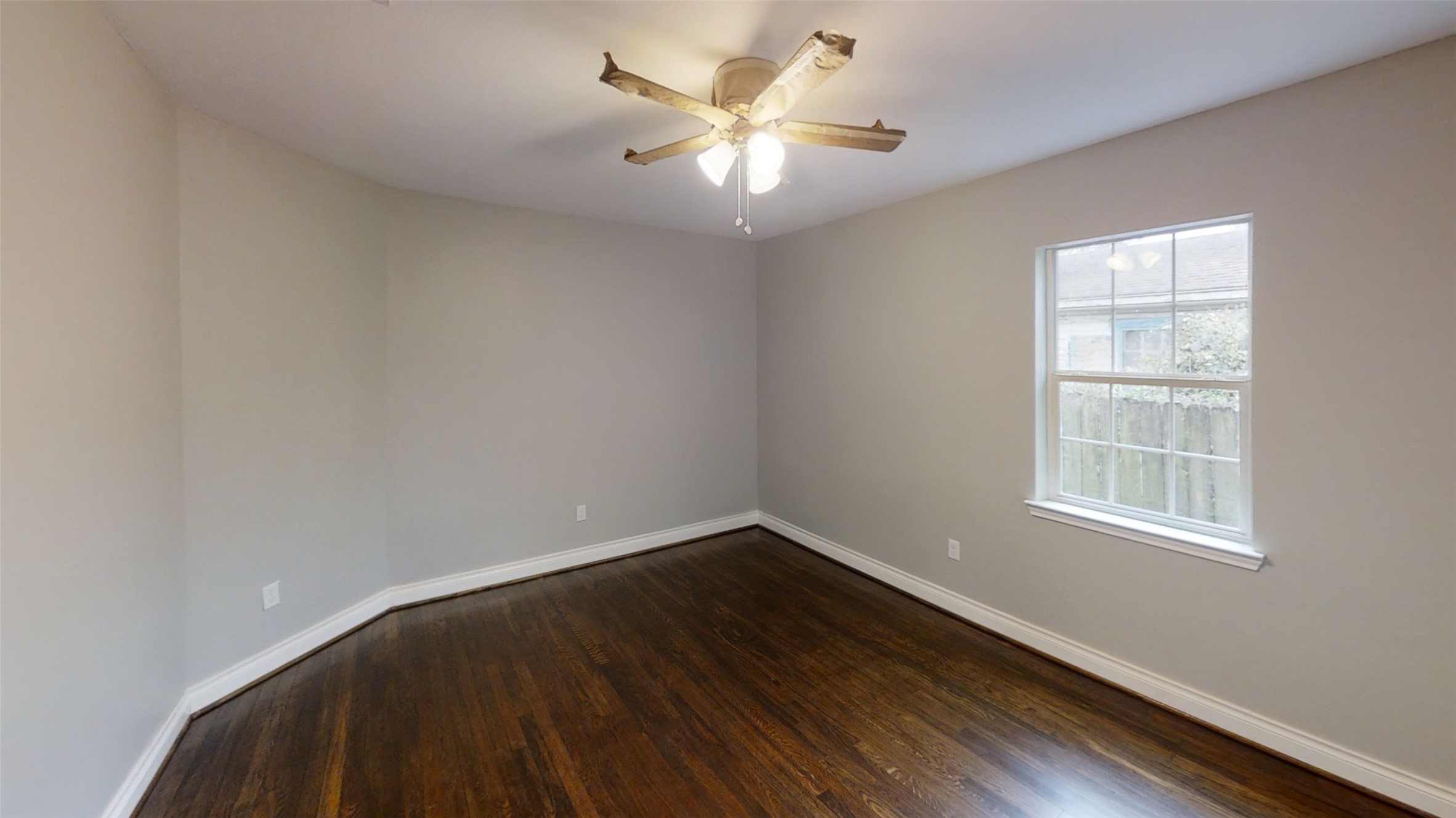 4323 Alice Street Houston, TX 77021 - Photo 8 of 11 an empty room with wooden floor and windows