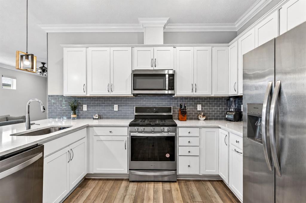6427 Mooring Line Circle Apollo Beach, FL 33572 - Photo 15 of 34 a kitchen with cabinets stainless steel appliances and a counter space