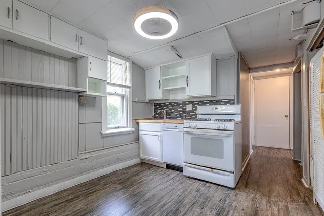 a view of a room with wooden floor and windows