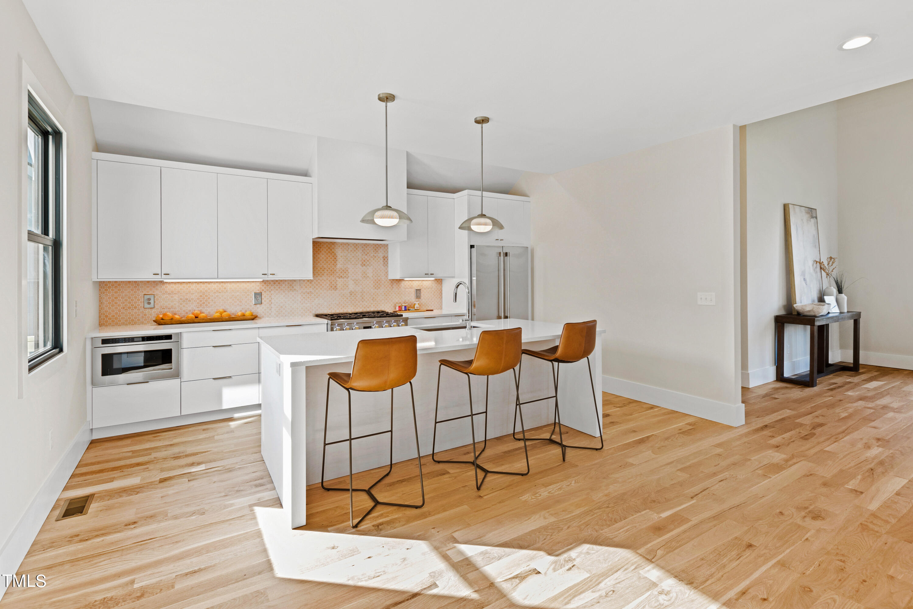 107 Gary Road Carrboro, NC 27510 - Photo 11 of 34 a living room with furniture a wooden floor and kitchen view