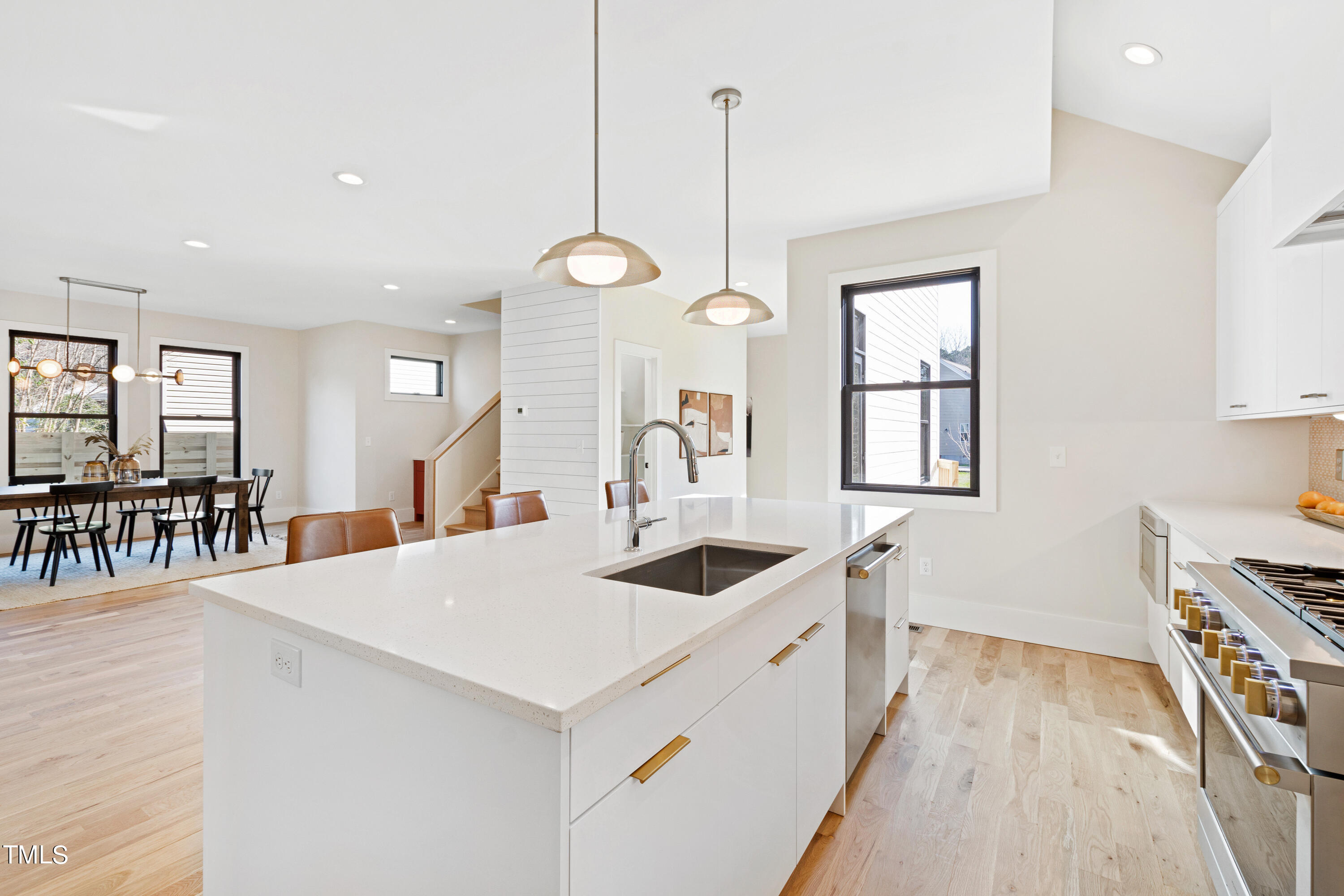 107 Gary Road Carrboro, NC 27510 - Photo 12 of 34 a kitchen with stainless steel appliances kitchen island a large counter tops and a view of living room