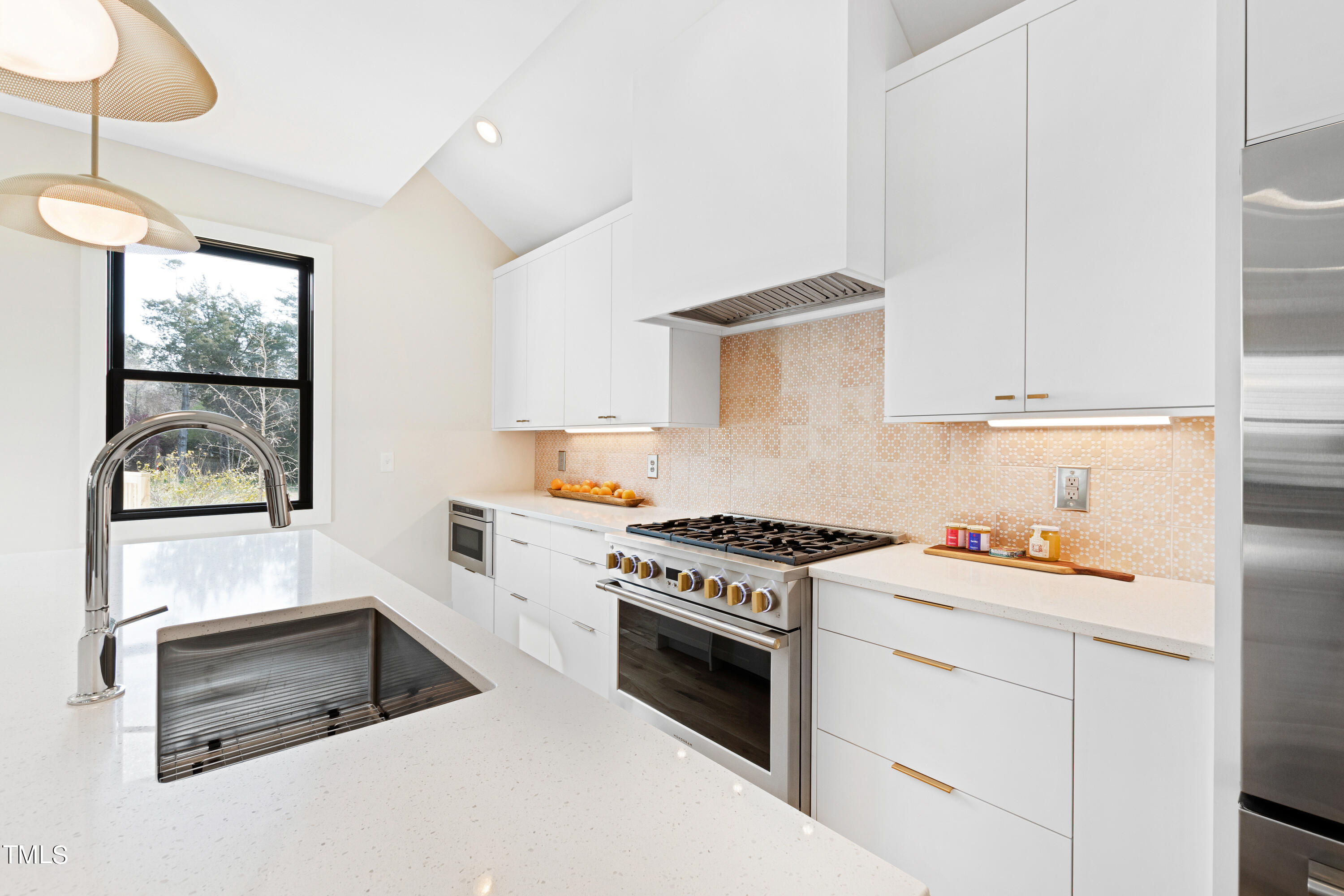 107 Gary Road Carrboro, NC 27510 - Photo 17 of 34 a kitchen with white cabinets and white appliances