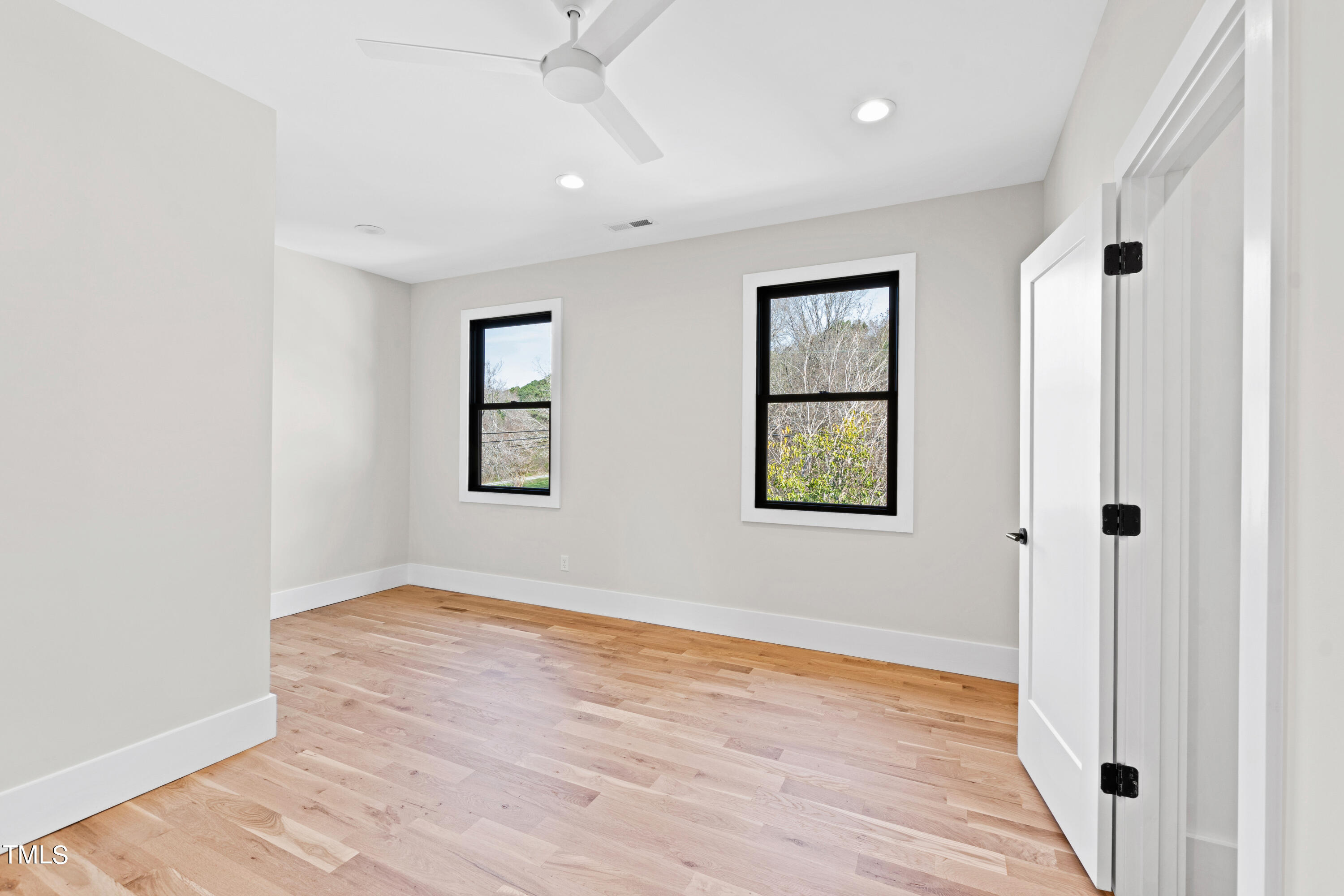 107 Gary Road Carrboro, NC 27510 - Photo 29 of 34 an empty room with wooden floor and windows