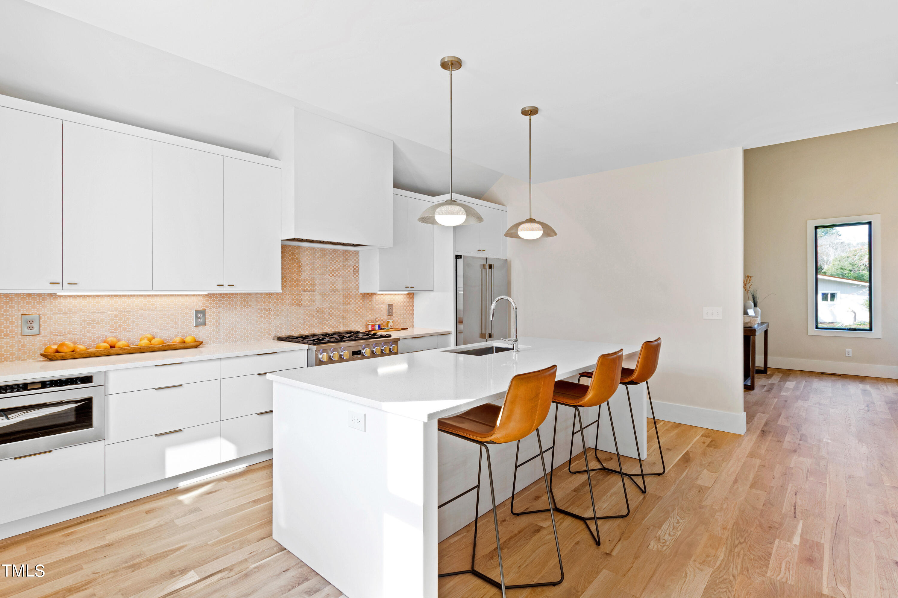 107 Gary Road Carrboro, NC 27510 - Photo 9 of 34 a kitchen with stainless steel appliances a stove a sink a center island and a refrigerator