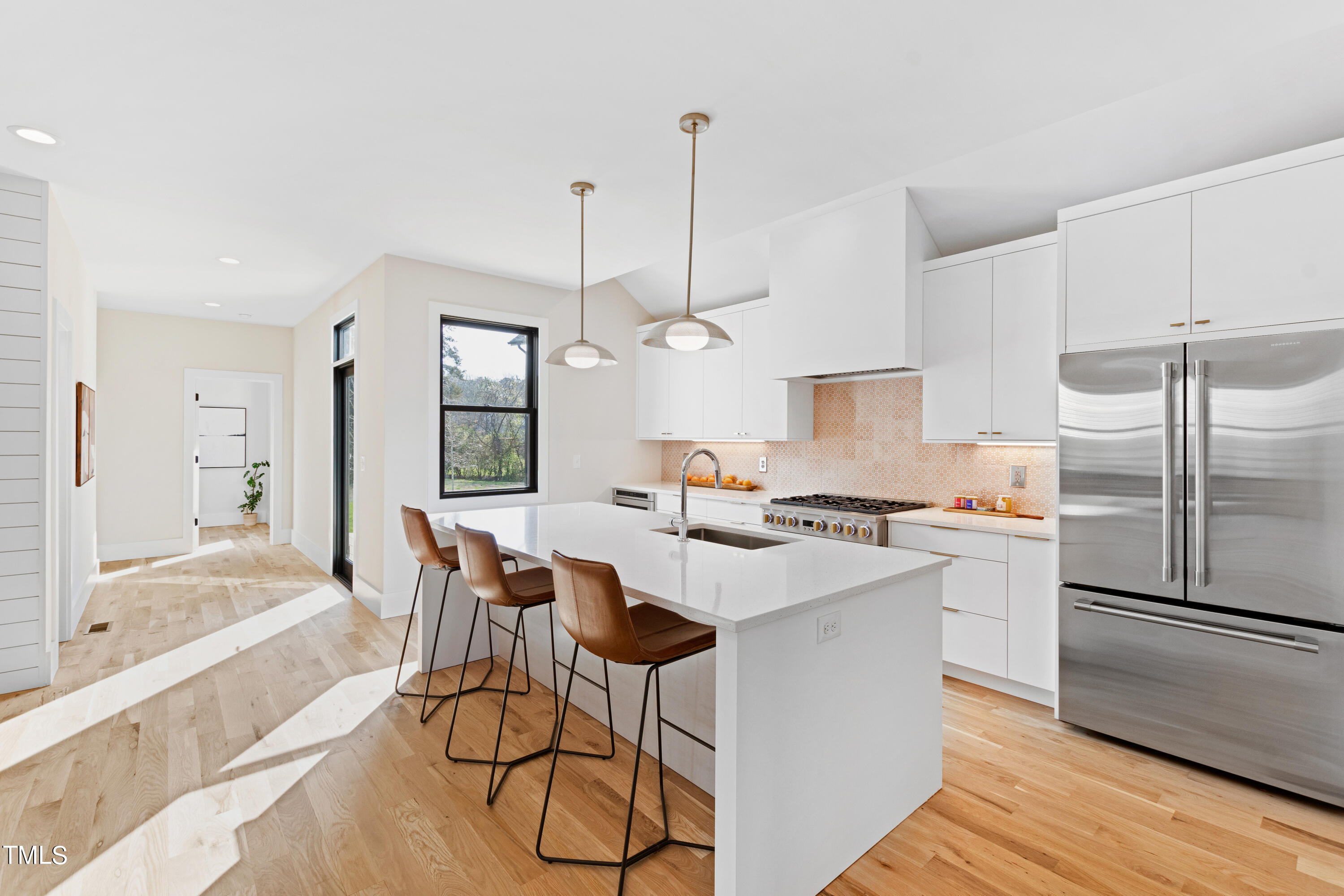 107 Gary Road Carrboro, NC 27510 - Photo 10 of 34 a kitchen with stainless steel appliances a dining table chairs stove and refrigerator