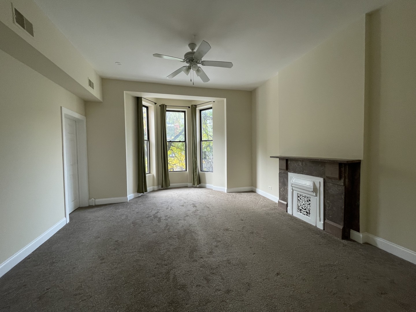 733 North Wells Street, Unit 2 Chicago, IL 60654 - Photo 3 of 12 a view of an empty room with a fireplace and a window