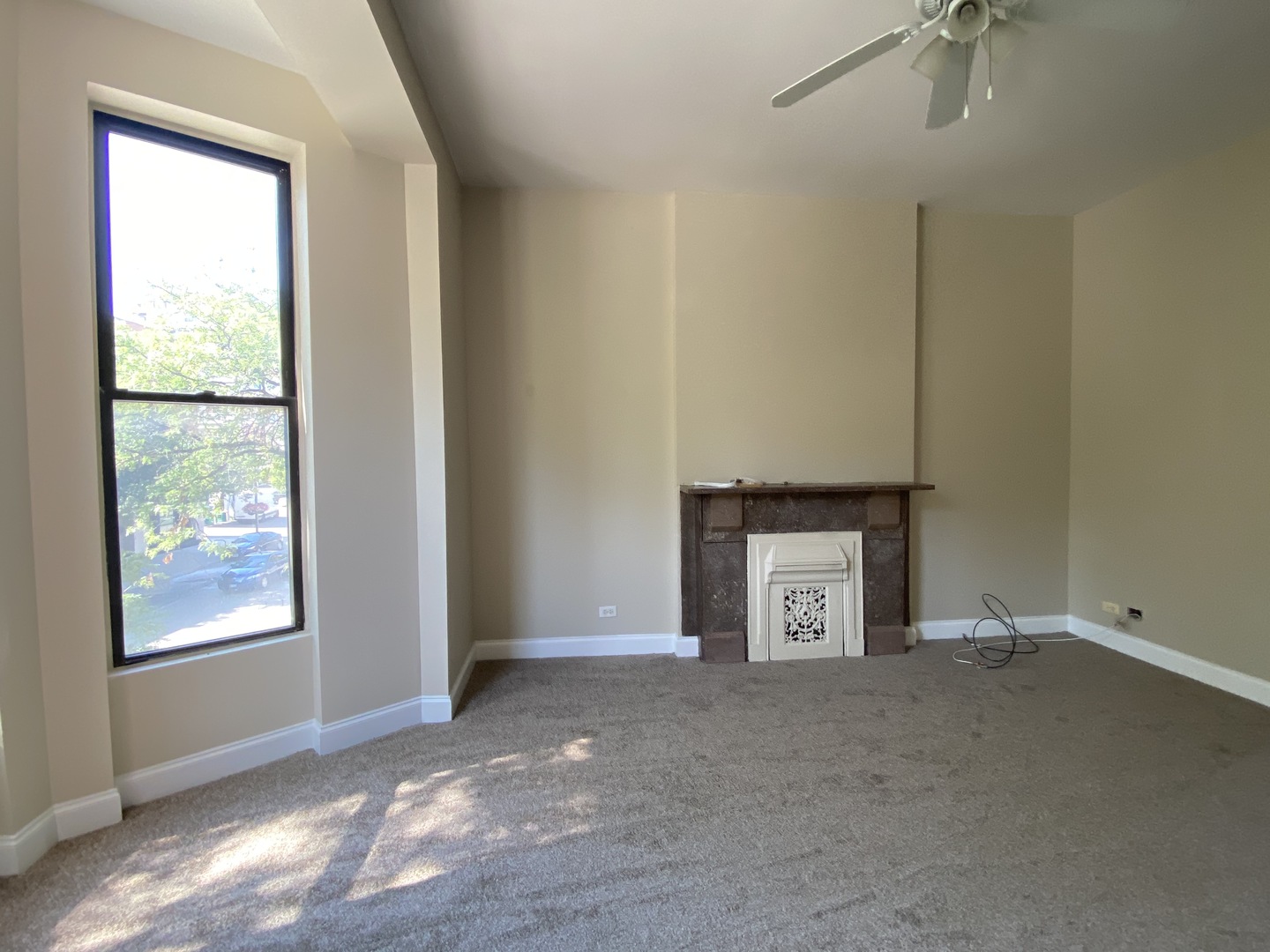 733 North Wells Street, Unit 2 Chicago, IL 60654 - Photo 4 of 12 a view of an empty room with a fireplace and a window