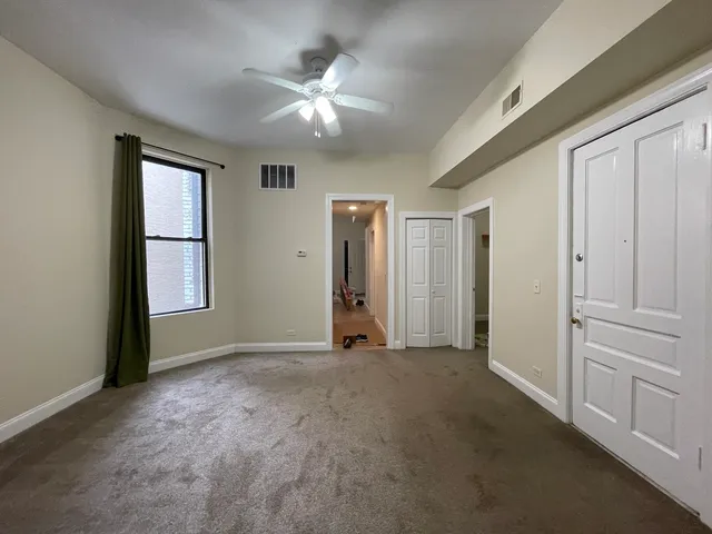 an empty room with windows and closet