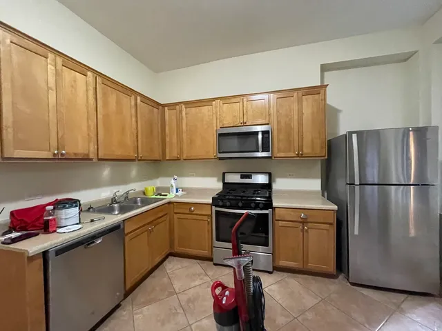 a kitchen with a sink appliances and cabinets