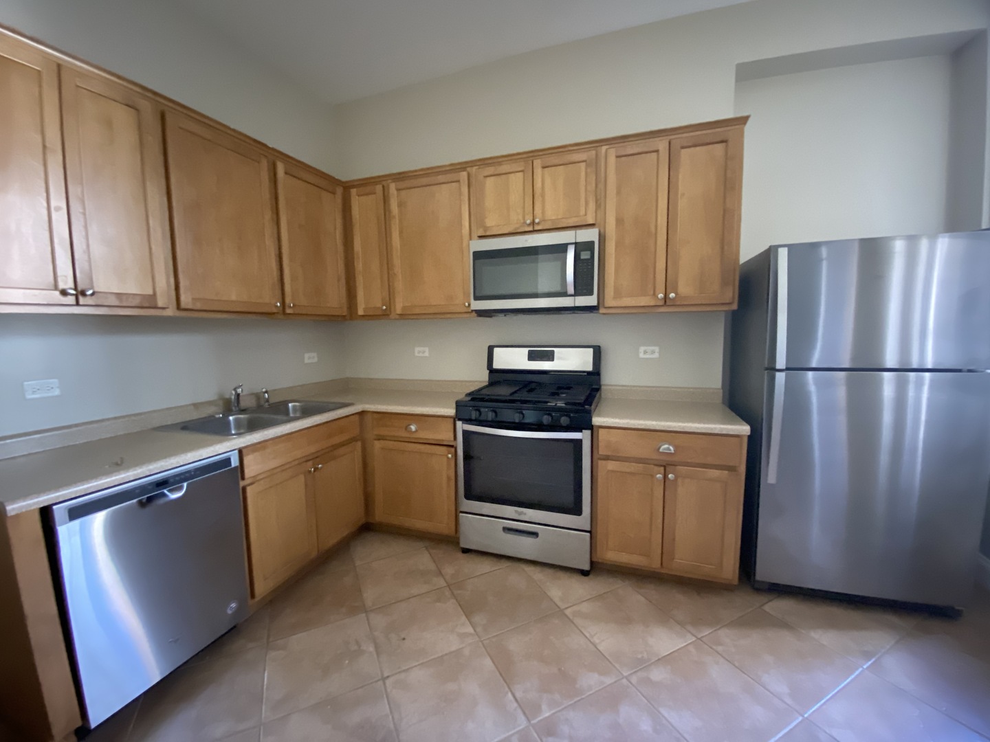 733 North Wells Street, Unit 2 Chicago, IL 60654 - Photo 7 of 12 a kitchen with stainless steel appliances granite countertop a refrigerator stove a sink and dishwasher
