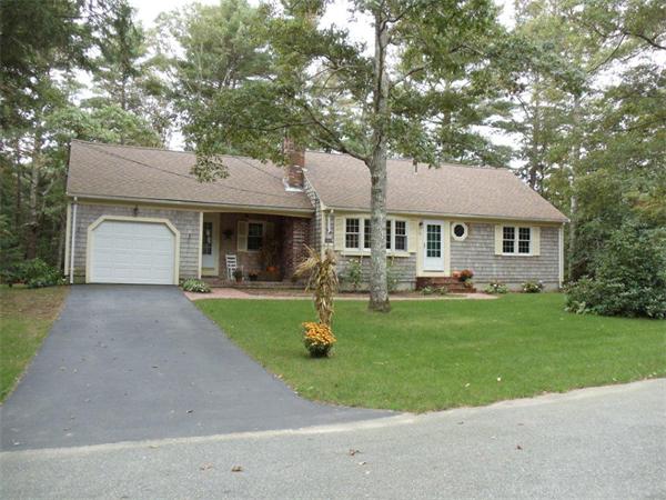 41 Yawl Road Barnstable, MA 02655 - Photo 1 of 25 a front view of a house with a yard and trees