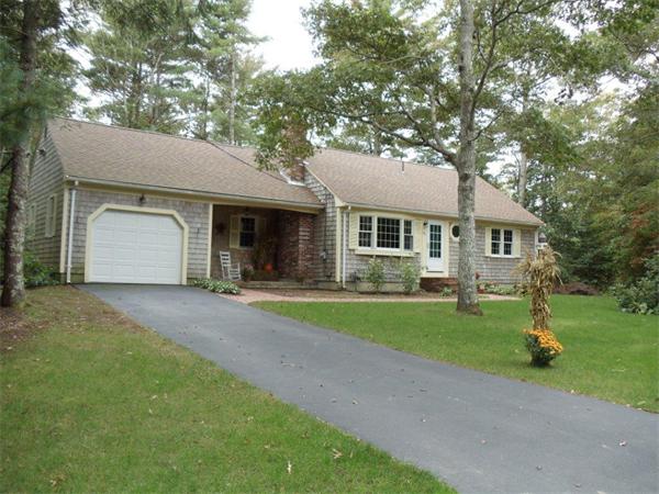 41 Yawl Road Barnstable, MA 02655 - Photo 4 of 25 a front view of a house with a garden and trees