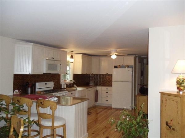 41 Yawl Road Barnstable, MA 02655 - Photo 6 of 25 a kitchen with stainless steel appliances kitchen island granite countertop a refrigerator a stove a microwave oven a sink with island and chairs
