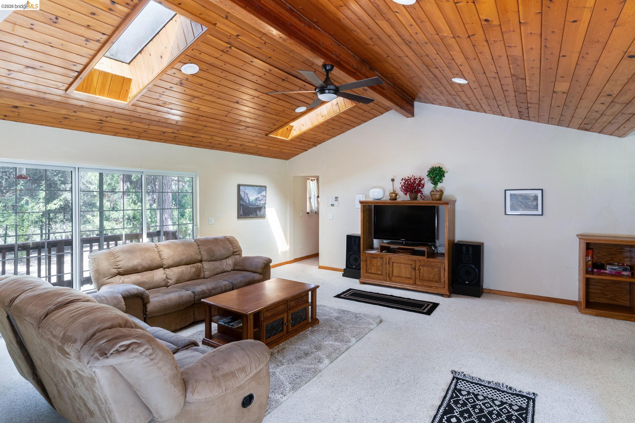 19390 Ferretti Road Groveland, CA 95321 - Photo 12 of 38 Vaulted wood-paneled ceiling with skylights and recessed lighting, accompanied by a ceiling fan